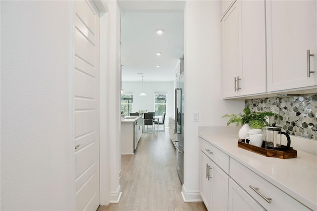 10139 Austrina Oak Loop, Winter Garden, FL 34787 - bar with light wood-style floors, recessed lighting, baseboards, tasteful backsplash, and high quality fridge