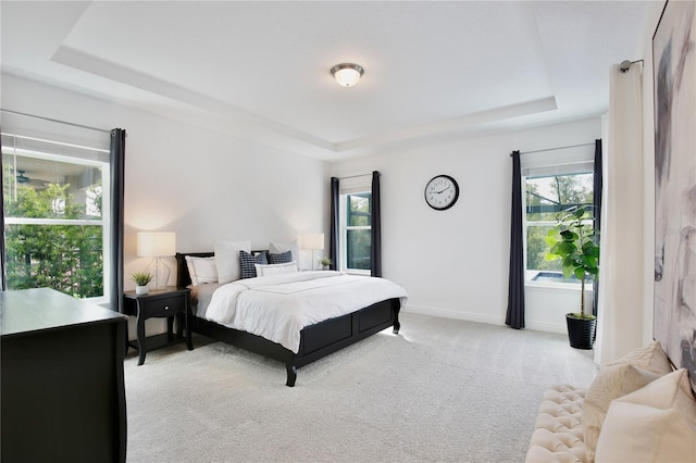 10139 Austrina Oak Loop, Winter Garden, FL 34787 - bedroom with baseboards, a raised ceiling, light carpet, and multiple windows