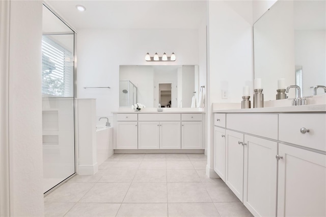 10139 Austrina Oak Loop, Winter Garden, FL 34787 - bathroom with a sink, tile patterned floors, two vanities, a shower stall, and a bath