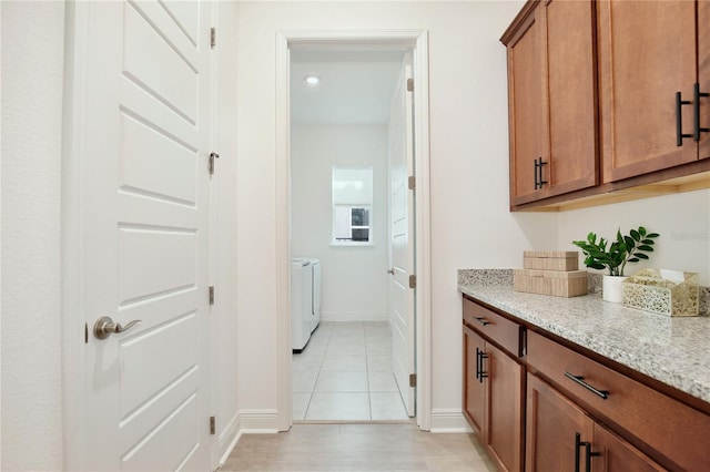 10139 Austrina Oak Loop, Winter Garden, FL 34787 - interior space featuring baseboards, independent washer and dryer, and light tile patterned floors