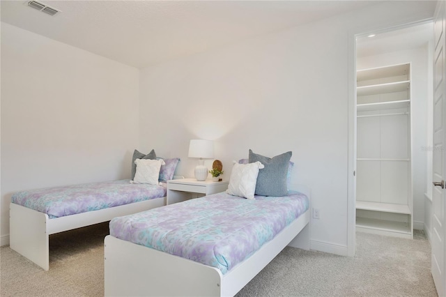 10139 Austrina Oak Loop, Winter Garden, FL 34787 - carpeted bedroom featuring a walk in closet, baseboards, and visible vents