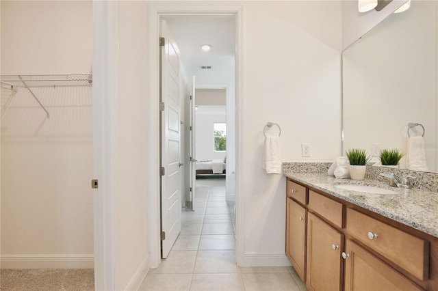 10139 Austrina Oak Loop, Winter Garden, FL 34787 - bathroom with visible vents, vanity, baseboards, tile patterned floors, and a spacious closet