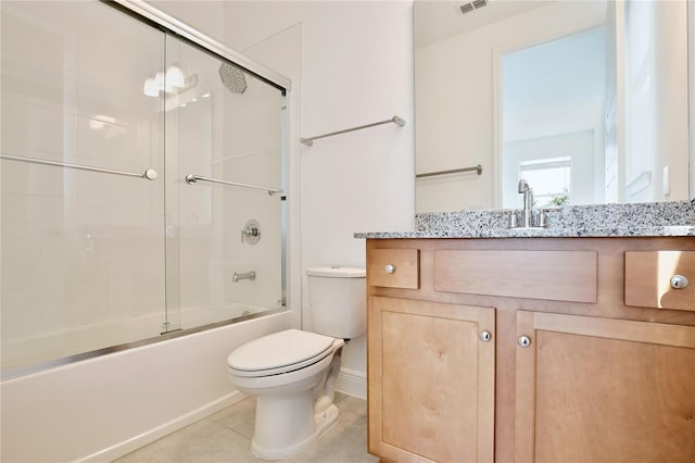 10139 Austrina Oak Loop, Winter Garden, FL 34787 - bathroom with tile patterned floors, vanity, baseboards, combined bath / shower with glass door, and toilet