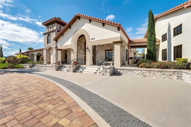 10139 Austrina Oak Loop, Winter Garden, FL 34787 - rear view of property with stucco siding, a tile roof, and stone siding