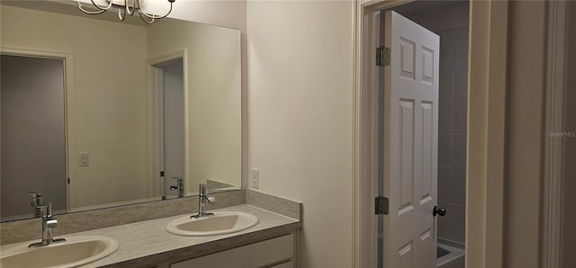 bathroom with double vanity, an inviting chandelier, tub / shower combination, and a sink