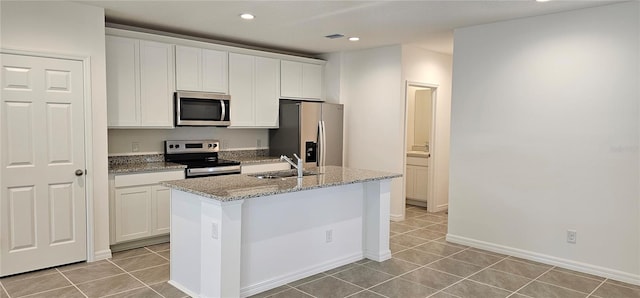 kitchen featuring recessed lighting, a sink, appliances with stainless steel finishes, and light tile patterned floors