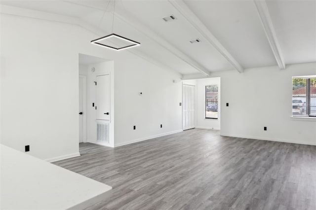 4510 Bonanza St, Cocoa, FL 32927 - unfurnished living room with visible vents, lofted ceiling with beams, and wood finished floors