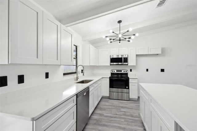 4510 Bonanza St, Cocoa, FL 32927 - kitchen featuring visible vents, a sink, a notable chandelier, vaulted ceiling with beams, and stainless steel appliances