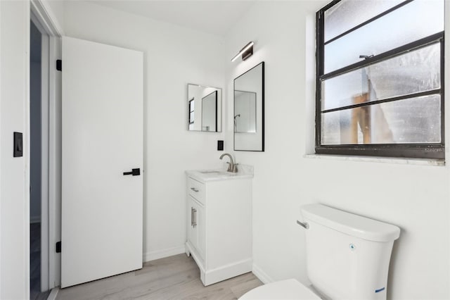 4510 Bonanza St, Cocoa, FL 32927 - bathroom with vanity, baseboards, toilet, and wood finished floors