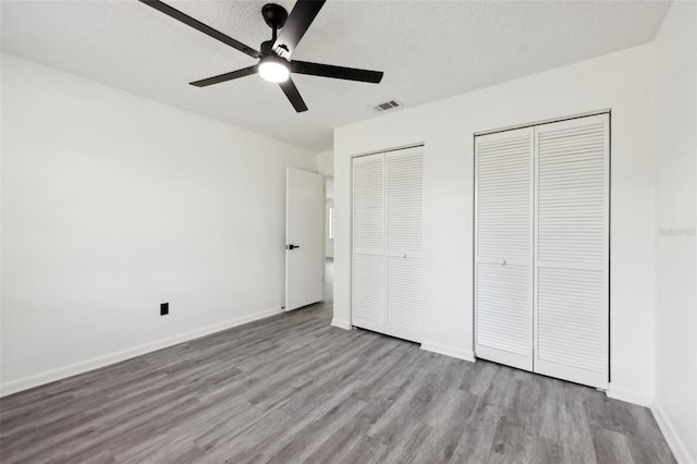 4510 Bonanza St, Cocoa, FL 32927 - unfurnished bedroom with baseboards, multiple closets, wood finished floors, and visible vents
