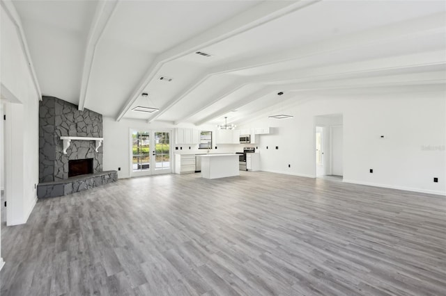 4510 Bonanza St, Cocoa, FL 32927 - unfurnished living room with a fireplace, lofted ceiling with beams, and wood finished floors