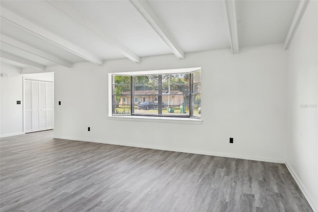 4510 Bonanza St, Cocoa, FL 32927 - unfurnished room with baseboards, beam ceiling, and wood finished floors