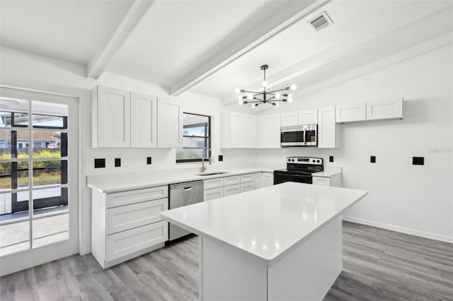 4510 Bonanza St, Cocoa, FL 32927 - kitchen with visible vents, appliances with stainless steel finishes, a sink, an inviting chandelier, and a wealth of natural light