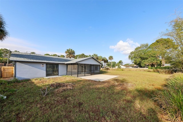 4510 Bonanza St, Cocoa, FL 32927 - back of property featuring a lawn, fence, a sunroom, and a patio area