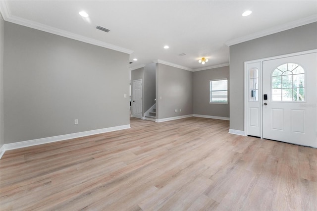 foyer with visible vents, light wood-type flooring, stairway, baseboards, and ornamental molding