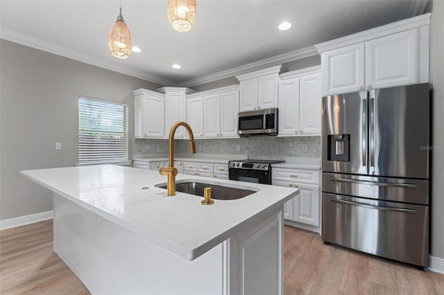 kitchen with white cabinets, a sink, light wood-style flooring, backsplash, and stainless steel appliances