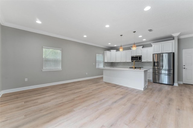 kitchen featuring appliances with stainless steel finishes, light countertops, white cabinetry, backsplash, and ornamental molding