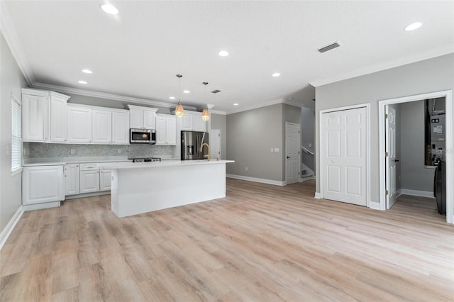 kitchen featuring light countertops, stainless steel appliances, baseboards, tasteful backsplash, and ornamental molding