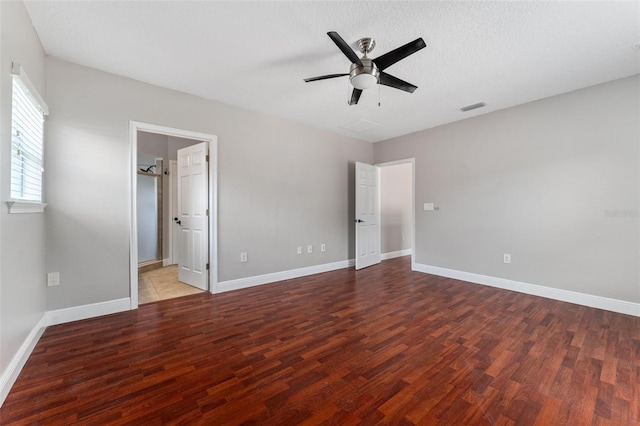 unfurnished bedroom featuring baseboards, ceiling fan, wood finished floors, and visible vents