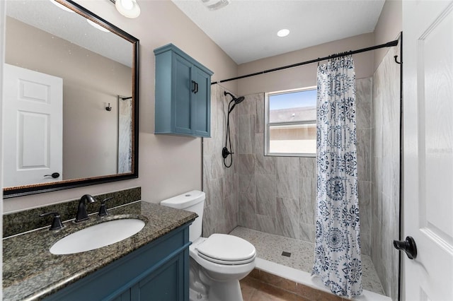 full bathroom with vanity, tile patterned floors, a shower stall, and toilet