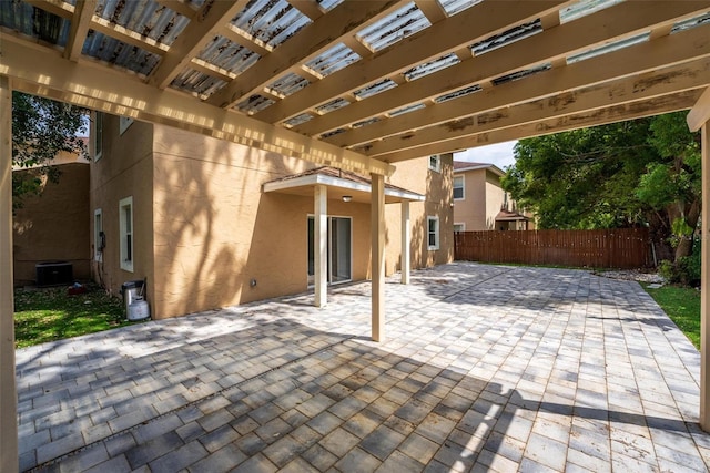 view of patio / terrace featuring fence, a pergola, and central AC unit