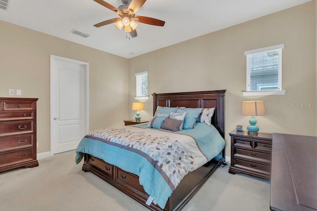 bedroom featuring baseboards, light carpet, a ceiling fan, and visible vents