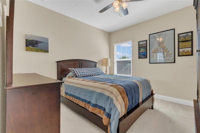 bedroom featuring baseboards, ceiling fan, and light carpet