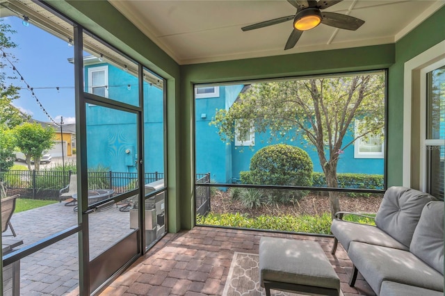 sunroom / solarium with a healthy amount of sunlight and ceiling fan