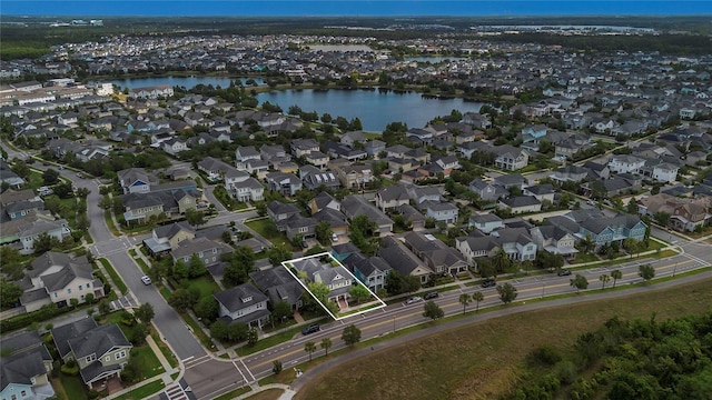 drone / aerial view featuring a water view and a residential view