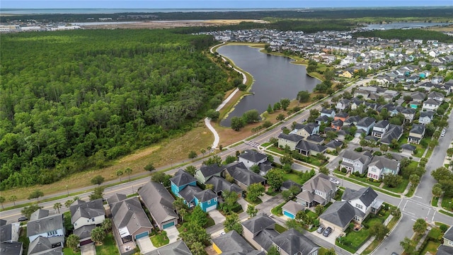 drone / aerial view with a water view, a residential view, and a forest view
