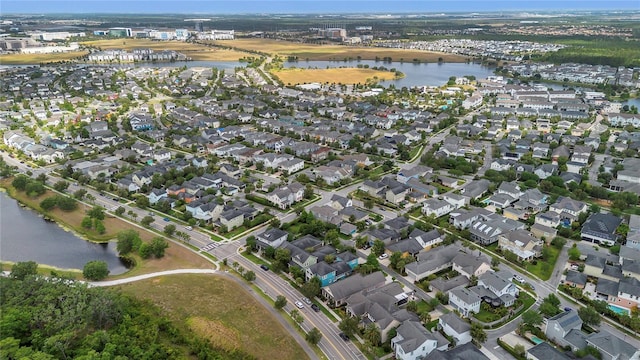 birds eye view of property featuring a water view and a residential view