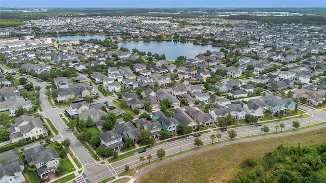 drone / aerial view with a water view and a residential view