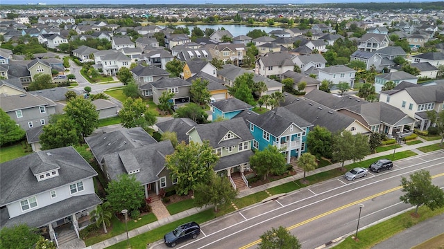 bird's eye view featuring a water view and a residential view
