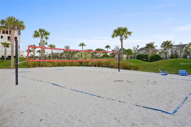 surrounding community with volleyball court and a yard
