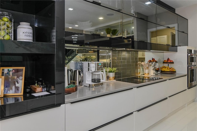 bar area featuring black electric cooktop, decorative backsplash, recessed lighting, and stainless steel double oven