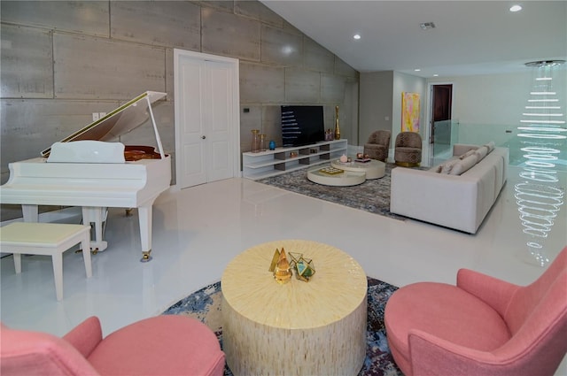 living area featuring vaulted ceiling and recessed lighting