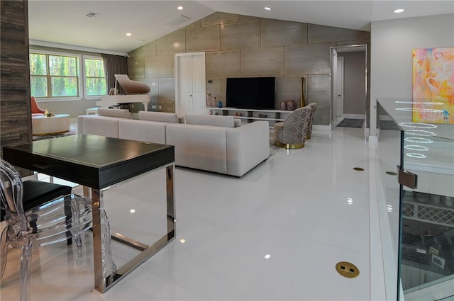 living room with vaulted ceiling and tile patterned floors