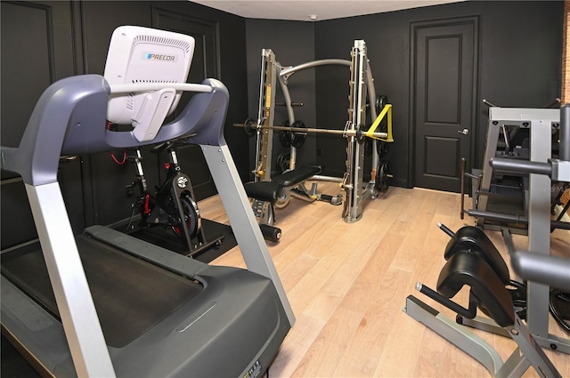 workout room featuring wood finished floors