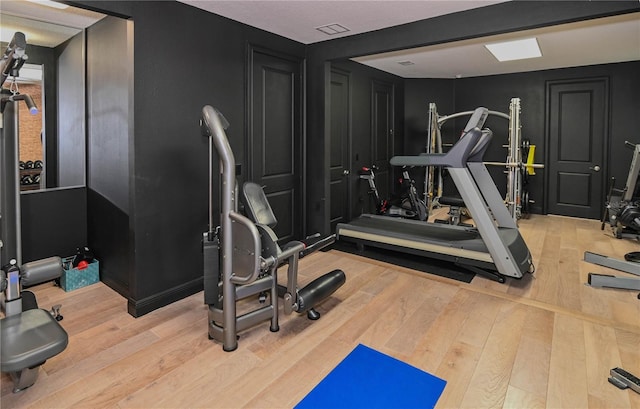 exercise room with wood finished floors