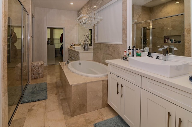full bath featuring a shower stall, a garden tub, vanity, recessed lighting, and a chandelier