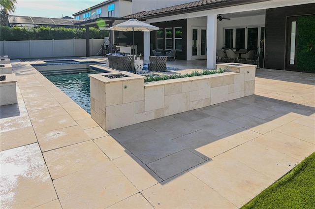 view of swimming pool with french doors, fence, a patio area, ceiling fan, and an in-ground hot tub