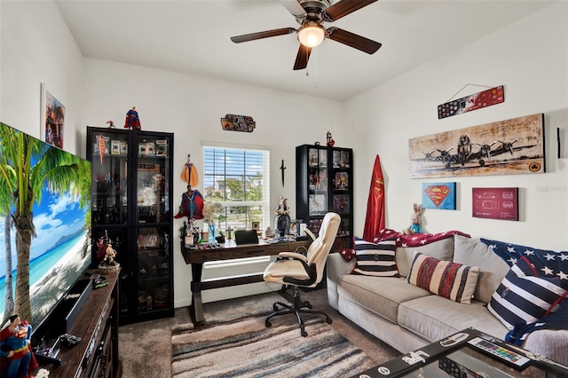 carpeted office with baseboards and a ceiling fan