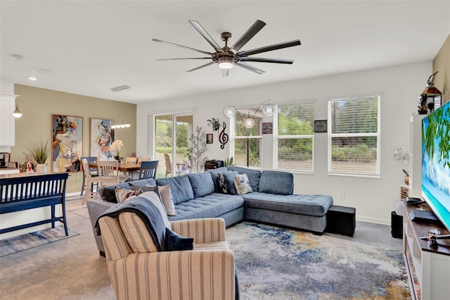 living room featuring baseboards and a ceiling fan