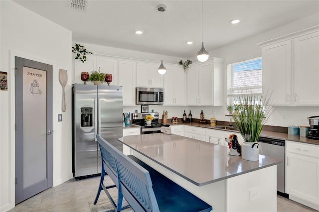 kitchen featuring white cabinetry, appliances with stainless steel finishes, and visible vents