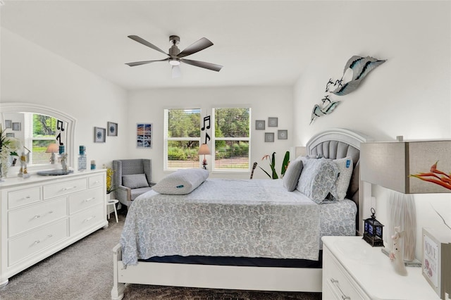 bedroom featuring light colored carpet and a ceiling fan