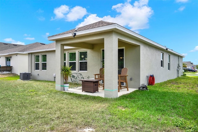 back of property featuring a lawn, a patio area, stucco siding, and cooling unit