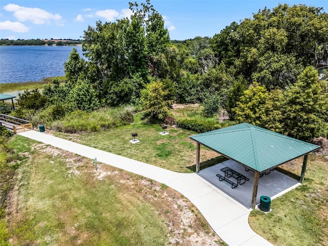 view of community with a lawn, a gazebo, and a water view