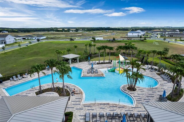 pool with a patio and fence