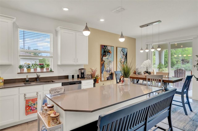 1880 Perch Hammock Loop, Groveland, FL 34736 - kitchen with a sink, dishwasher, white cabinets, a kitchen breakfast bar, and recessed lighting