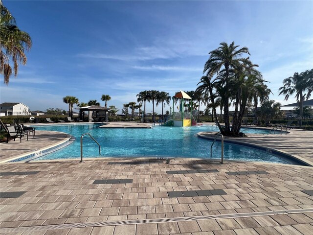 1880 Perch Hammock Loop, Groveland, FL 34736 - community pool featuring a patio area, a gazebo, and a water slide